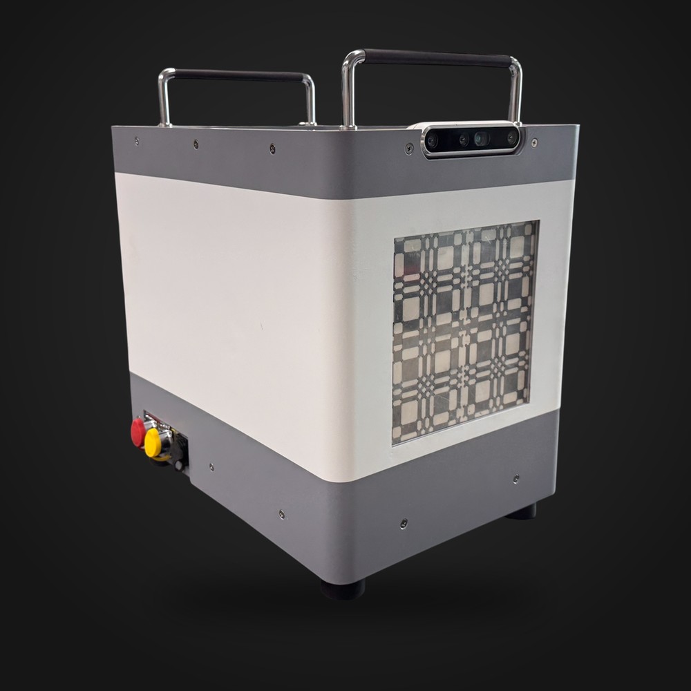 The RadLens C1 instrument: a portable enclosure with carry handles, a coded aperture mask on the front and a depth camera on top.
